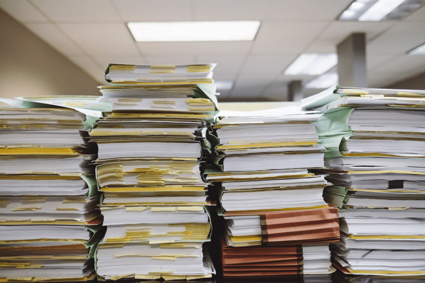 documents piled up on desk